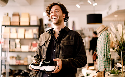 A shoe salesman holding a shoe