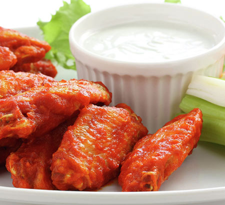 Buffalo wings with ranch on a plate