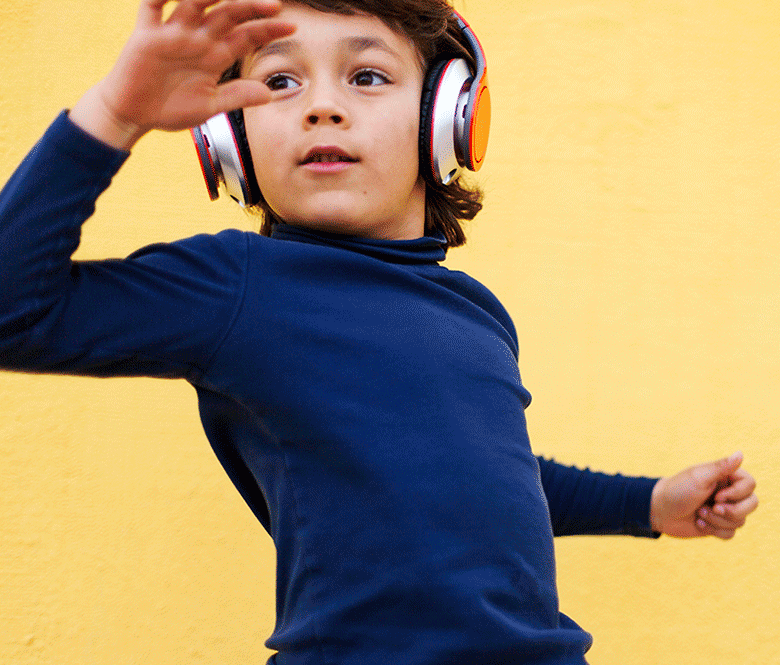 A boy wearing headphones and dancing