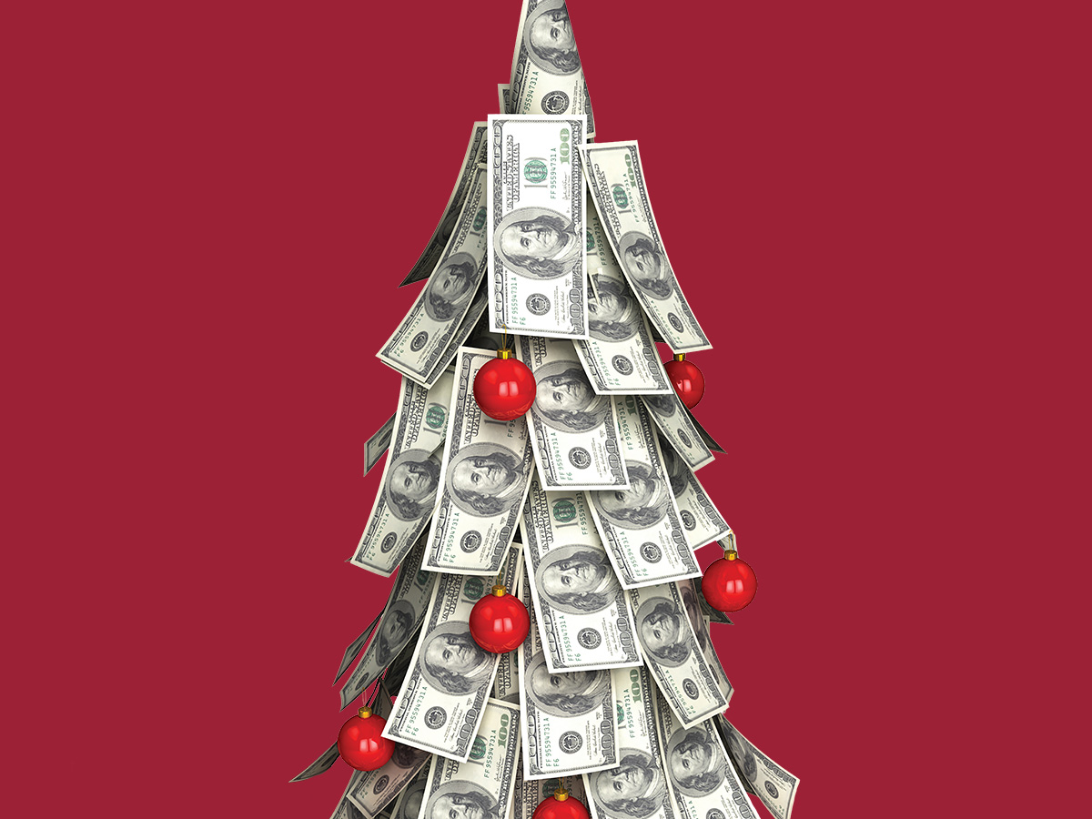 a Christmas tree made of folded $100 bills with red ornaments, set against a deep red background.


