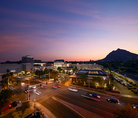 A portion of Scottsdale Fashion Square taken from above at dusk with traffic in the foreground