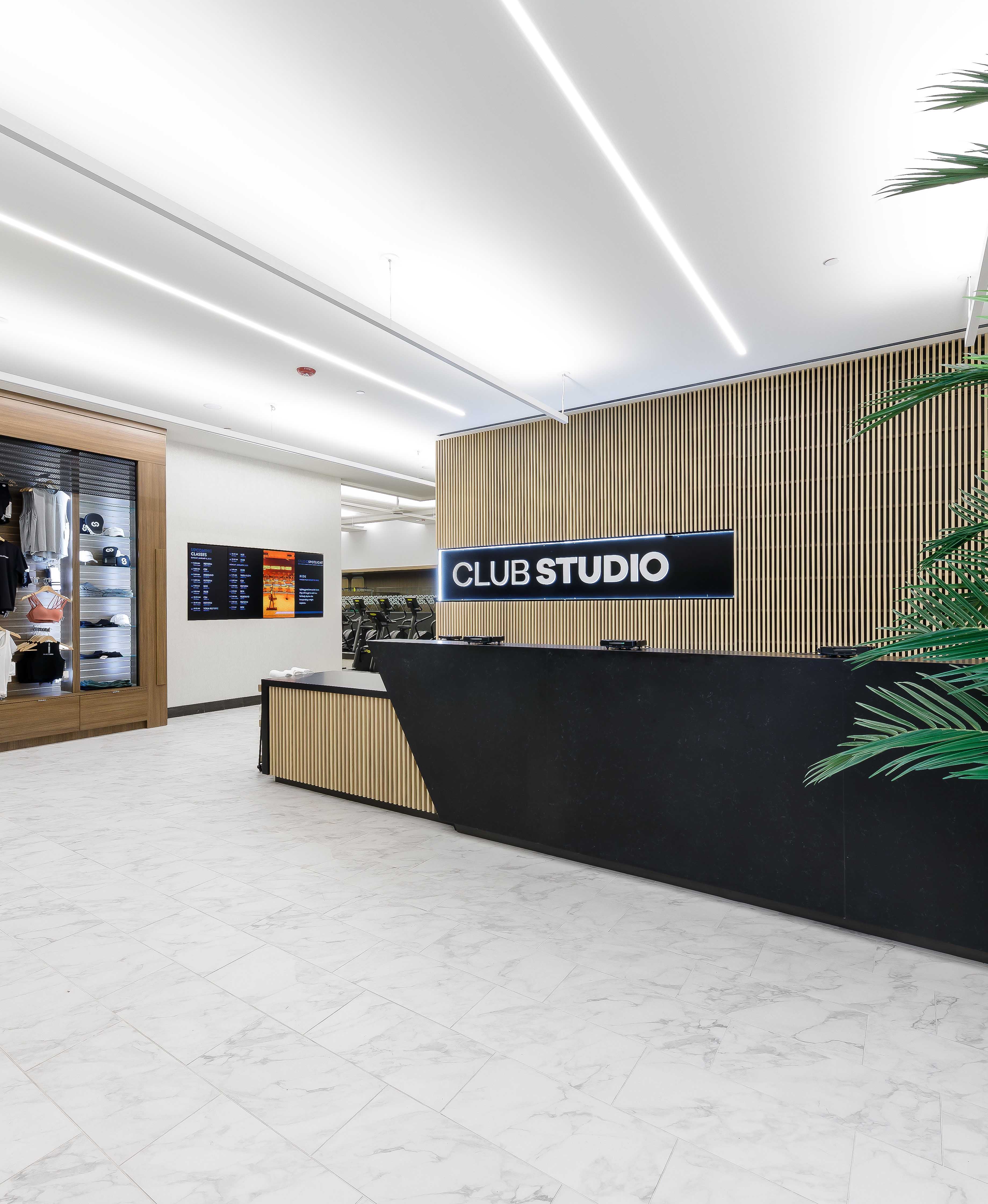 Club Studio interior image with front desk, workout apparel and Club Studio sign
