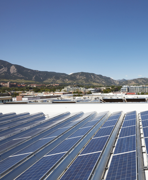 Solar Panels at FlatIron Crossing in Broomfield, Colorado, with rooftops and mountains in the background