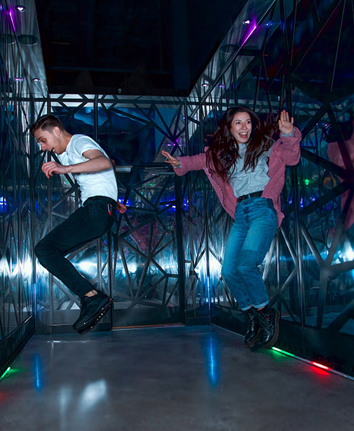 Two people jumping with excitement in the crystal jump room