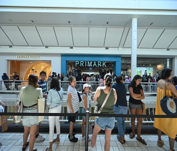 Interior mall with Primark and Kendra Scott storefront along with mall shoppers