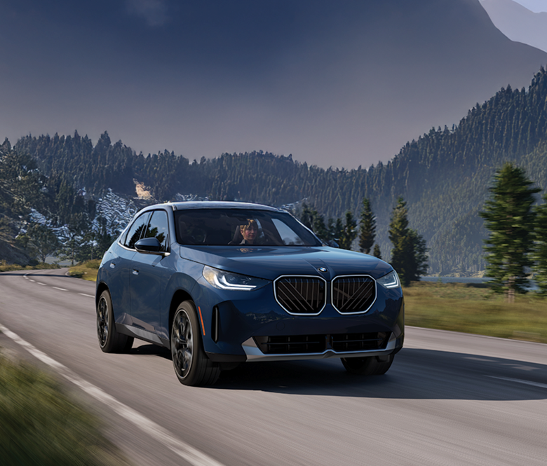 blue BMW SUV on a roadway