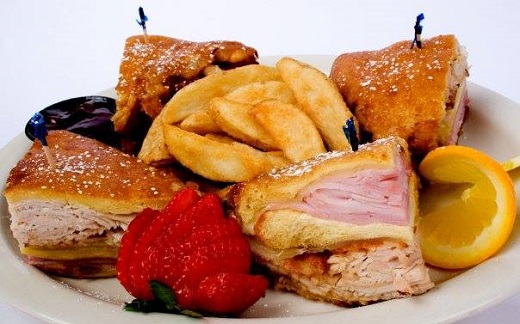 sandwich plate with fries, red strawberry and yellow lemon