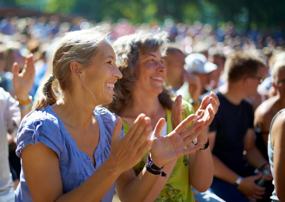 concert crowd with close up of two women smiling