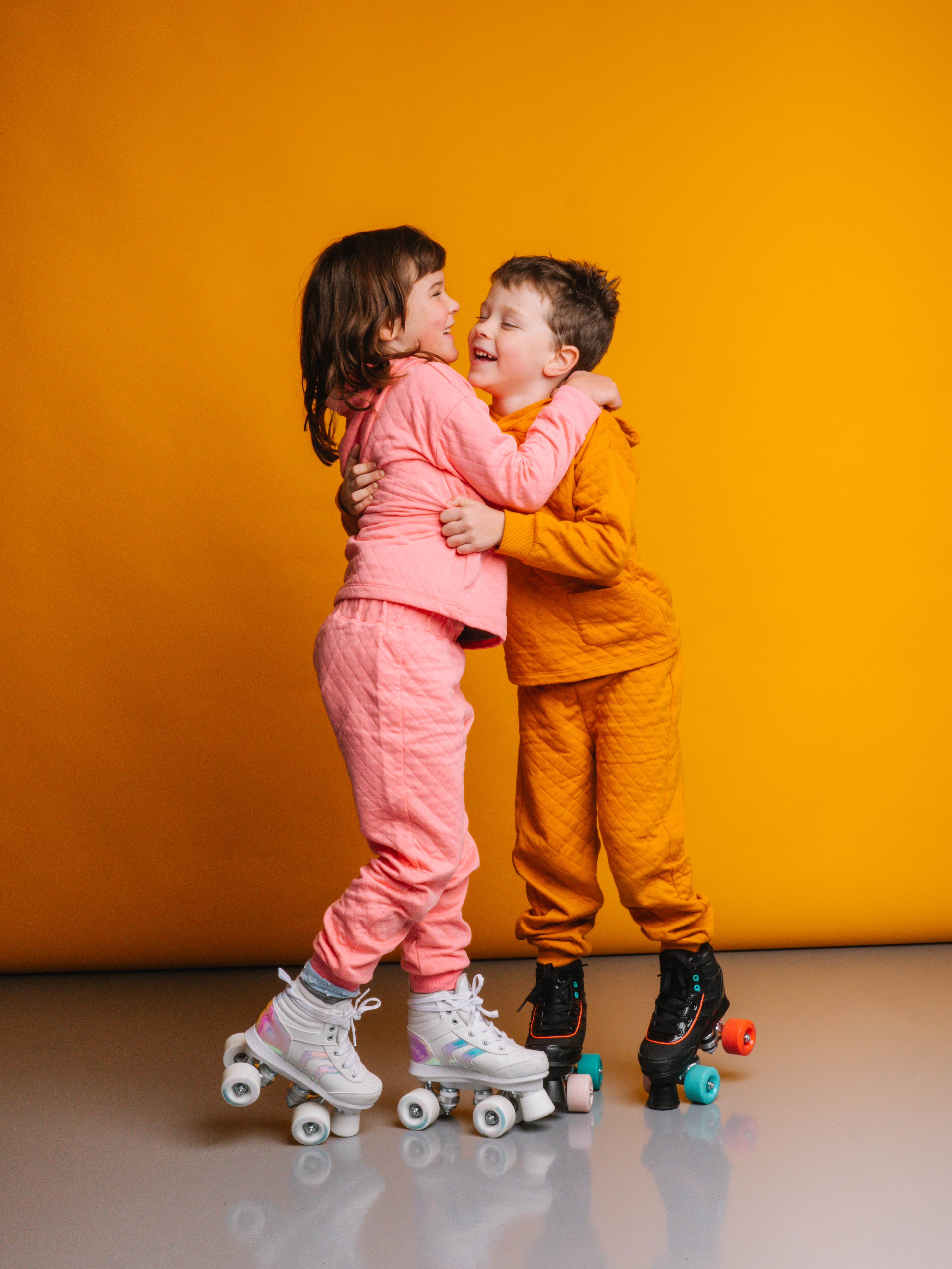 young boy and girl on roller skates