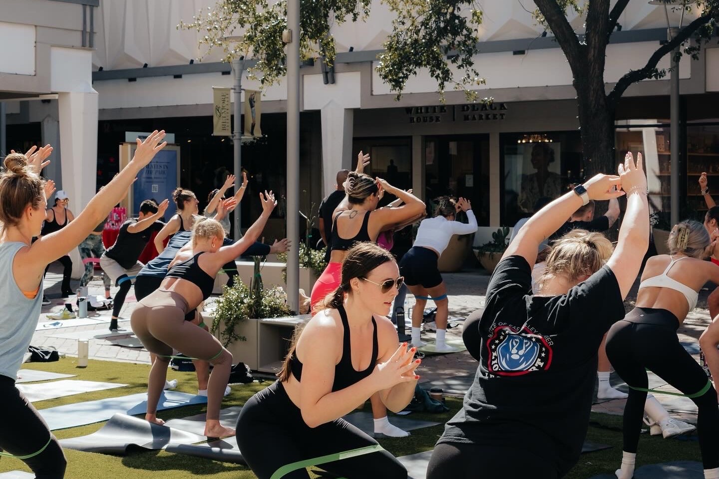 Group participating in an outdoor Pilates class. 