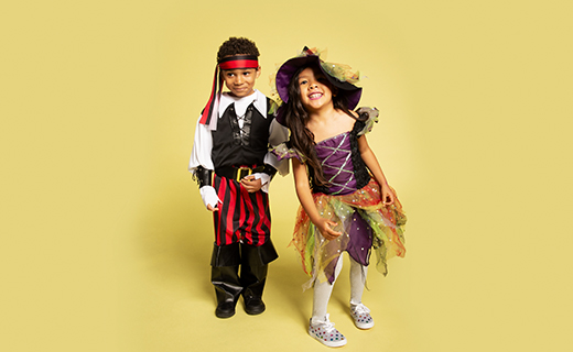 Two young children dressed in costumes.