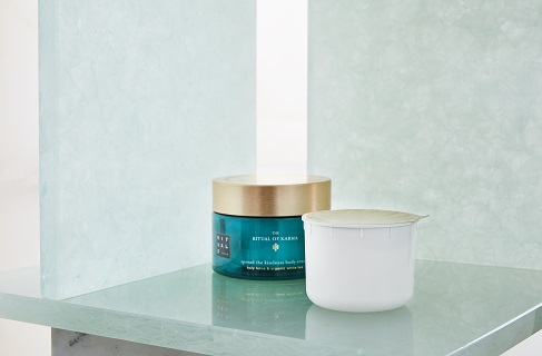 Karma body cream and refill on table.