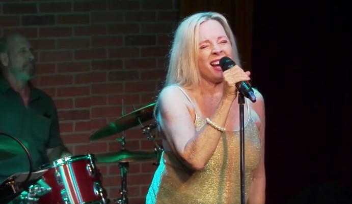 Alice Tatum, jazz singer, on stage singing. 