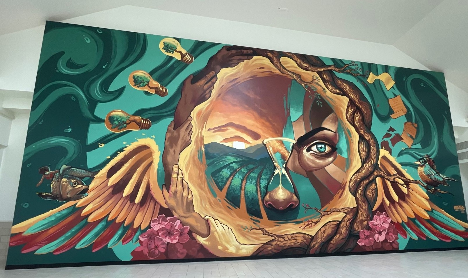 art mural with a face at the center and pieces of nature surrounding the face