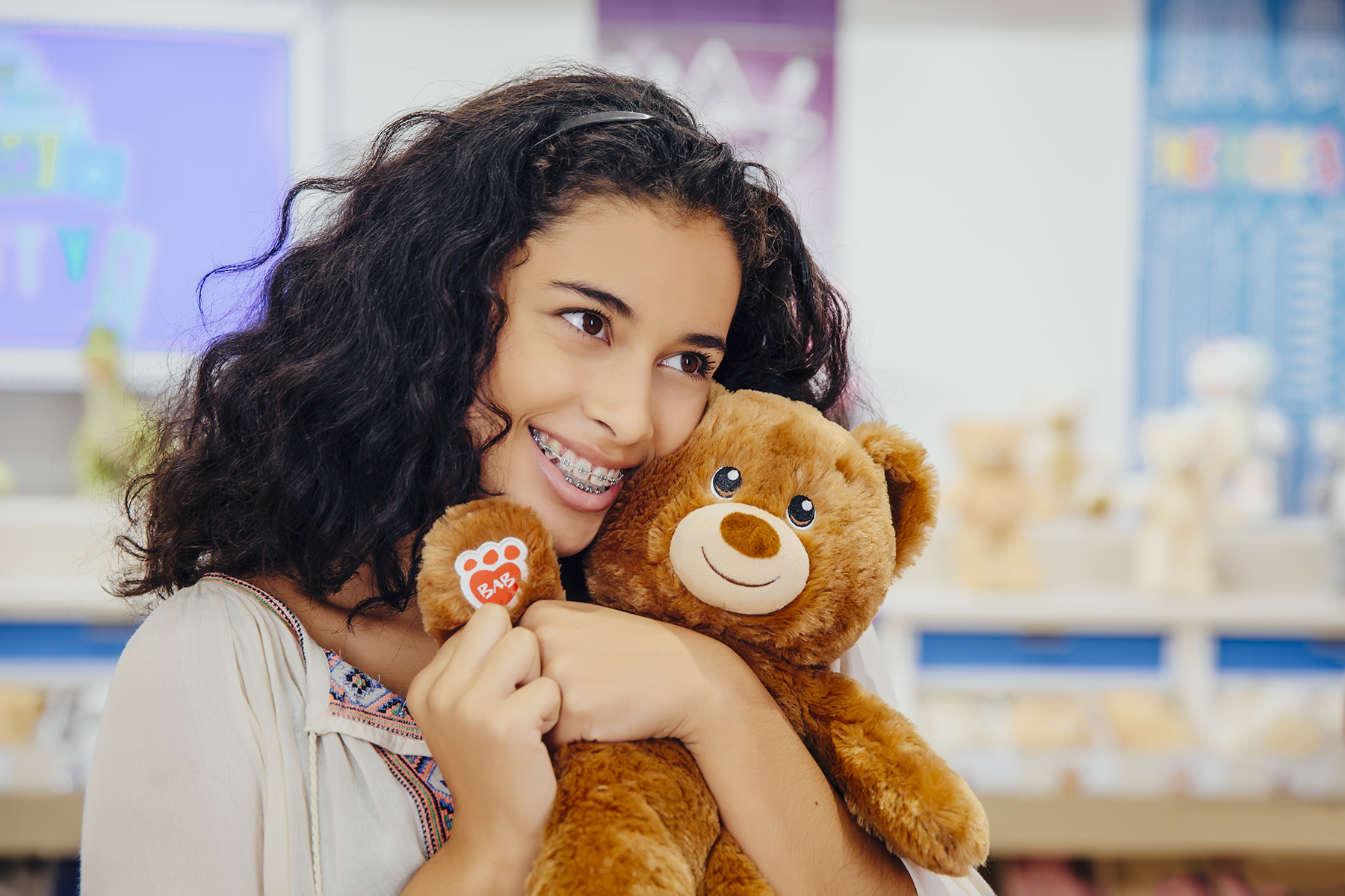 girl hugging a build-a-bear