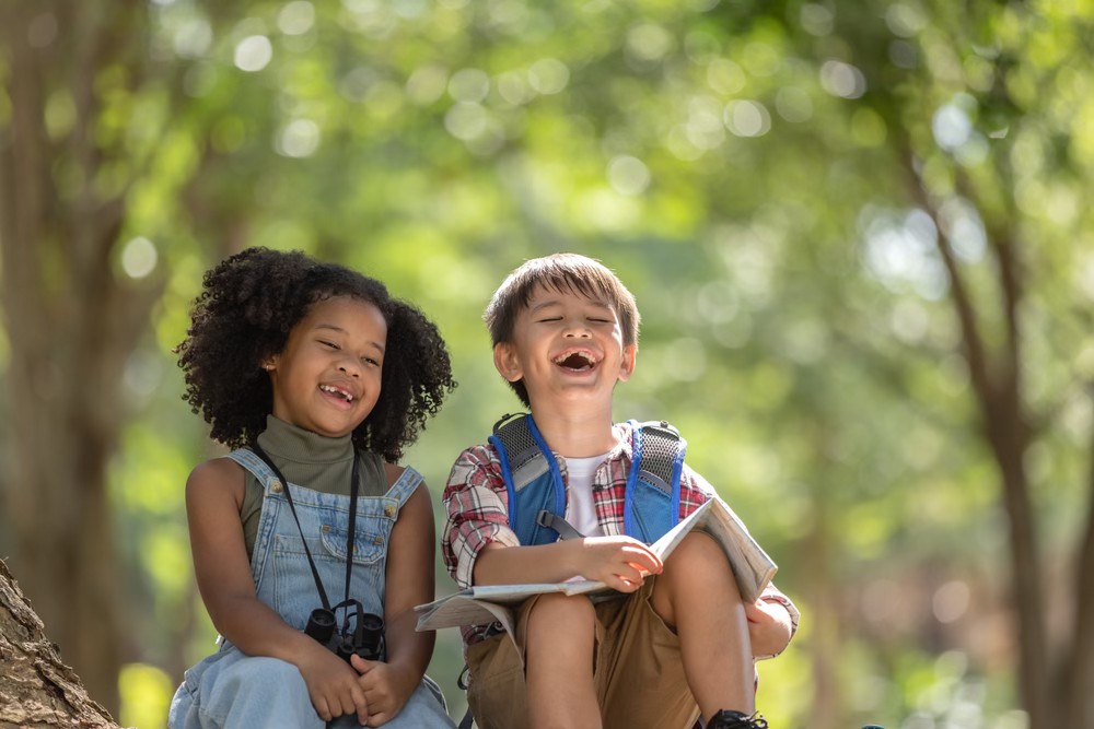 Two kids sitting outside