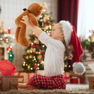 Little boy in pajamas holding a teddy bear