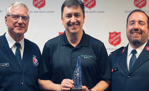 Marketing Manager Sean Ferguson gives the Nonprofit of the Month award to two members of The Salvation Army. 