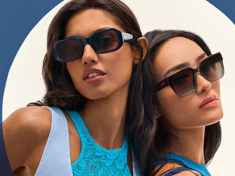 Two women wearing fashionable sunglasses