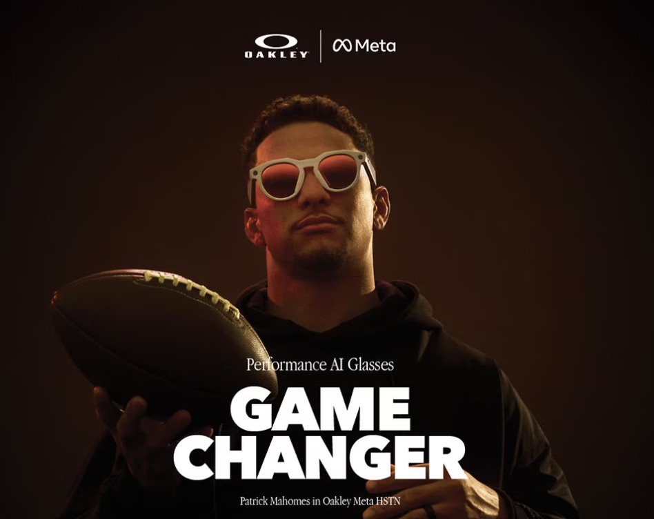 Patrick Mahomes holding a football and wearing Oakley Meta HSTN sunglasses.  
