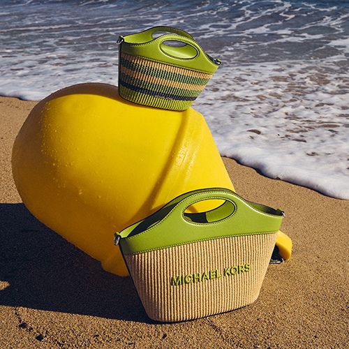 Michael Kors handbags on the beach sand