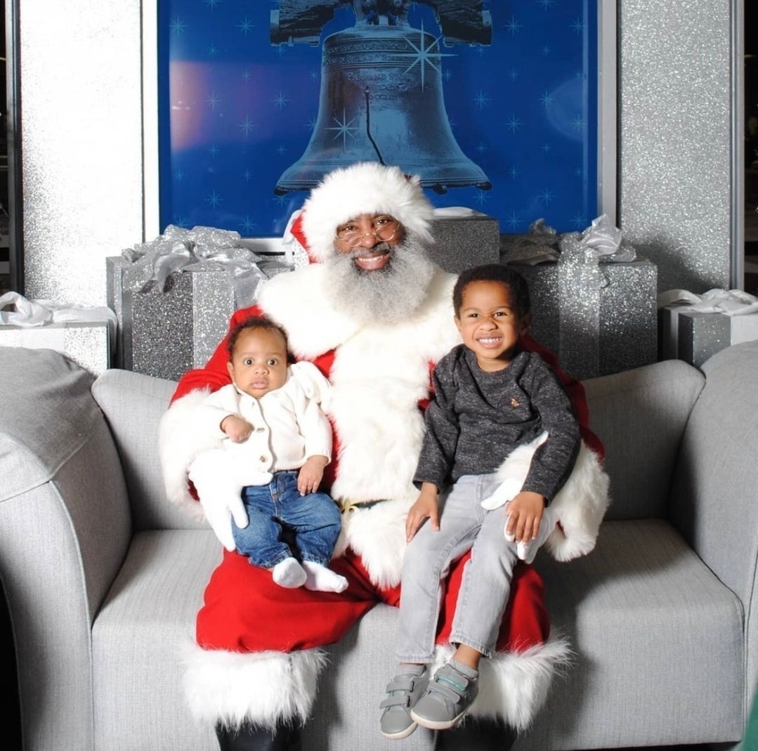 Black Santa with baby gift and a toddler boy. 