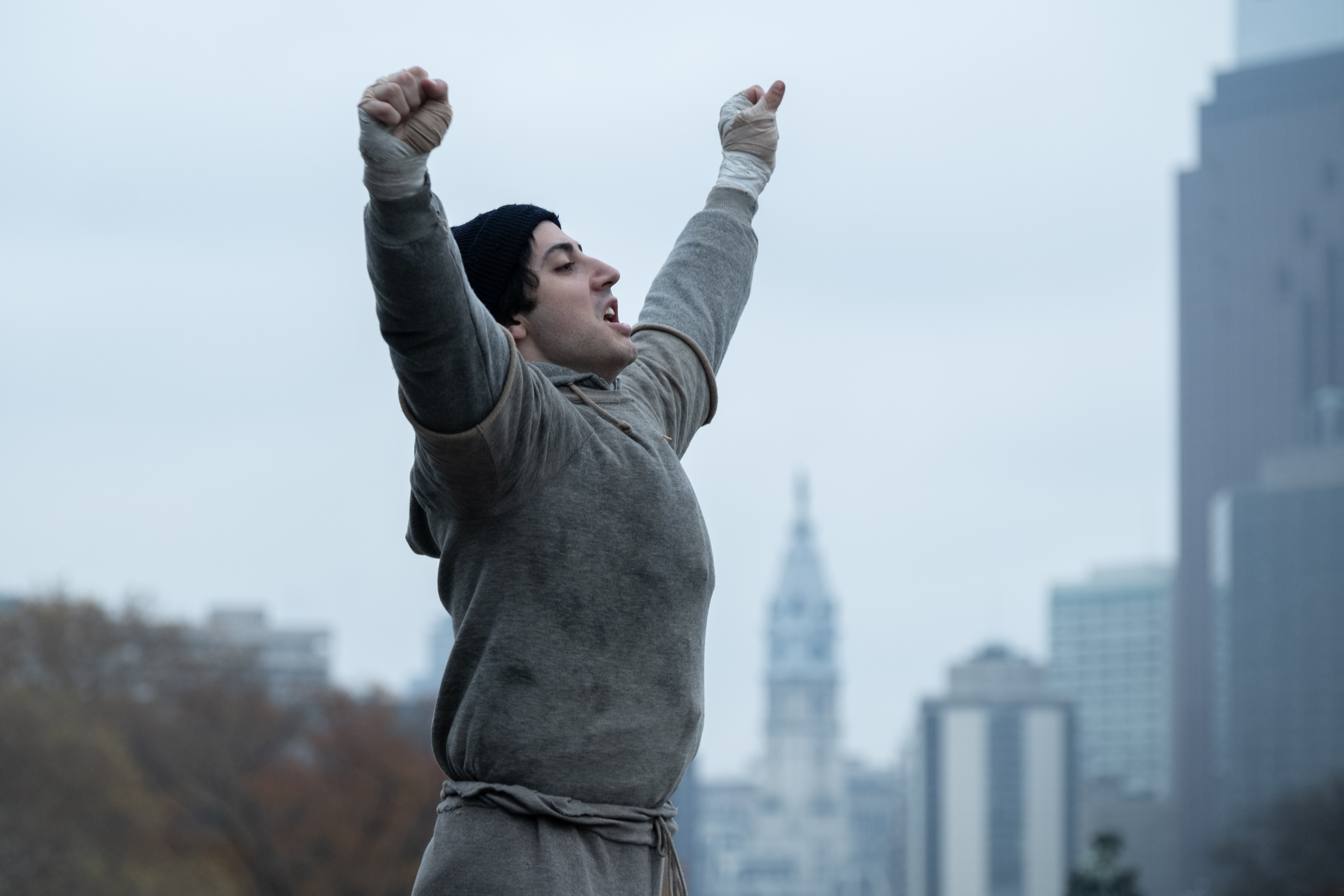 Photo of male raising his arms up in victory - famous Rocky pose.