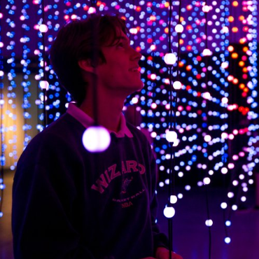 boy standing in light installation