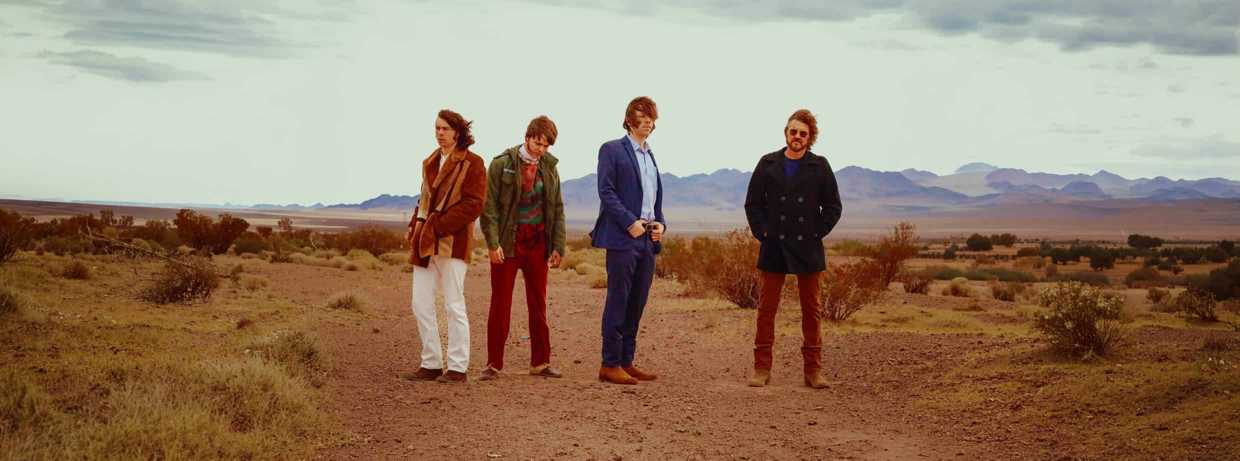 Photo of four men in desert 