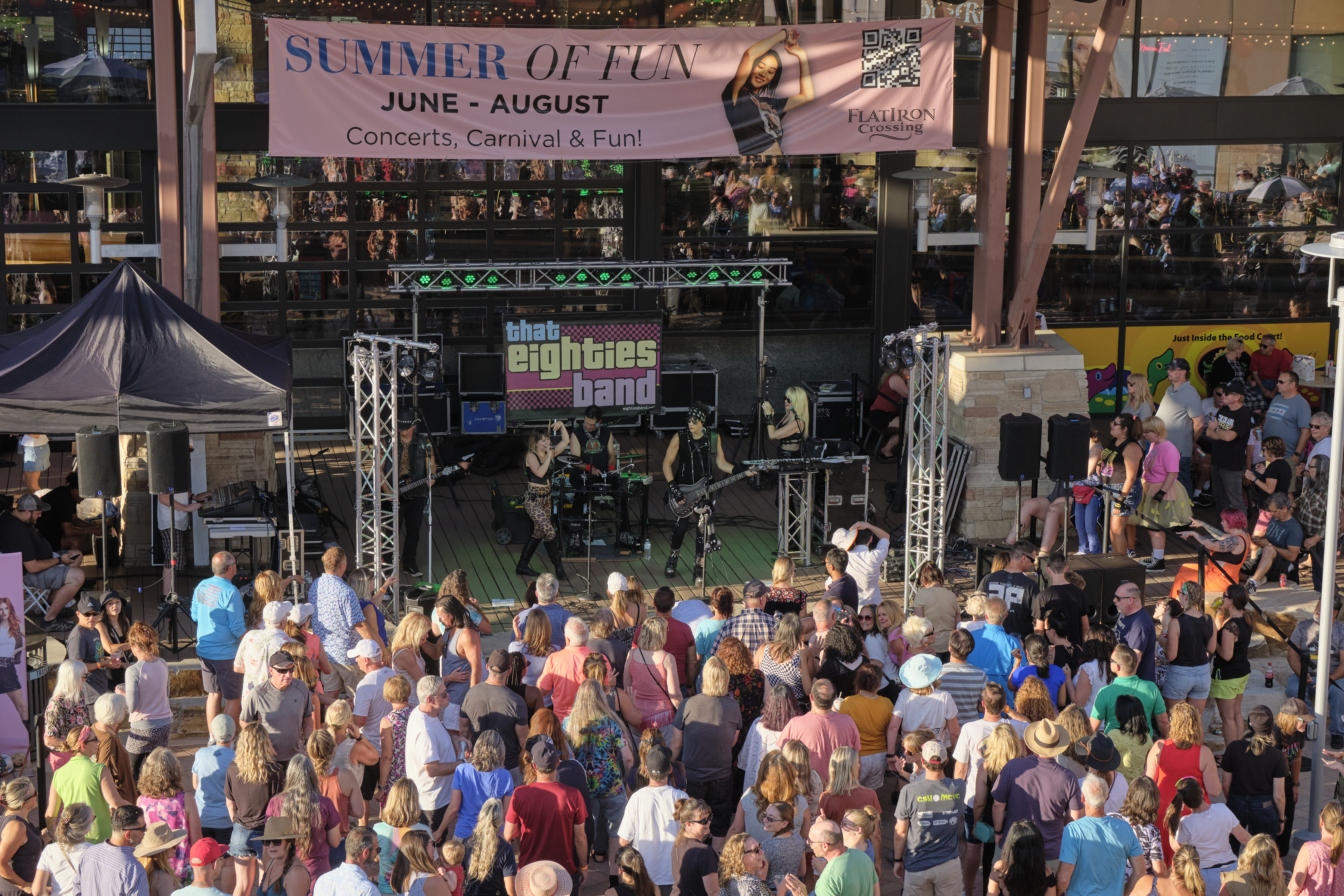 Concert crowd and band performing on stage. Text reads "Summer of Fun. June-August. Concerts, Carnival & Fun!"