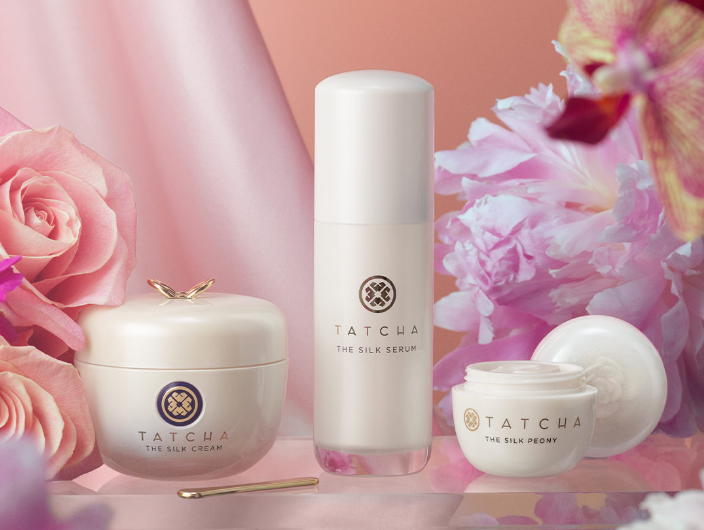 Skincare items with pink flowers in the background