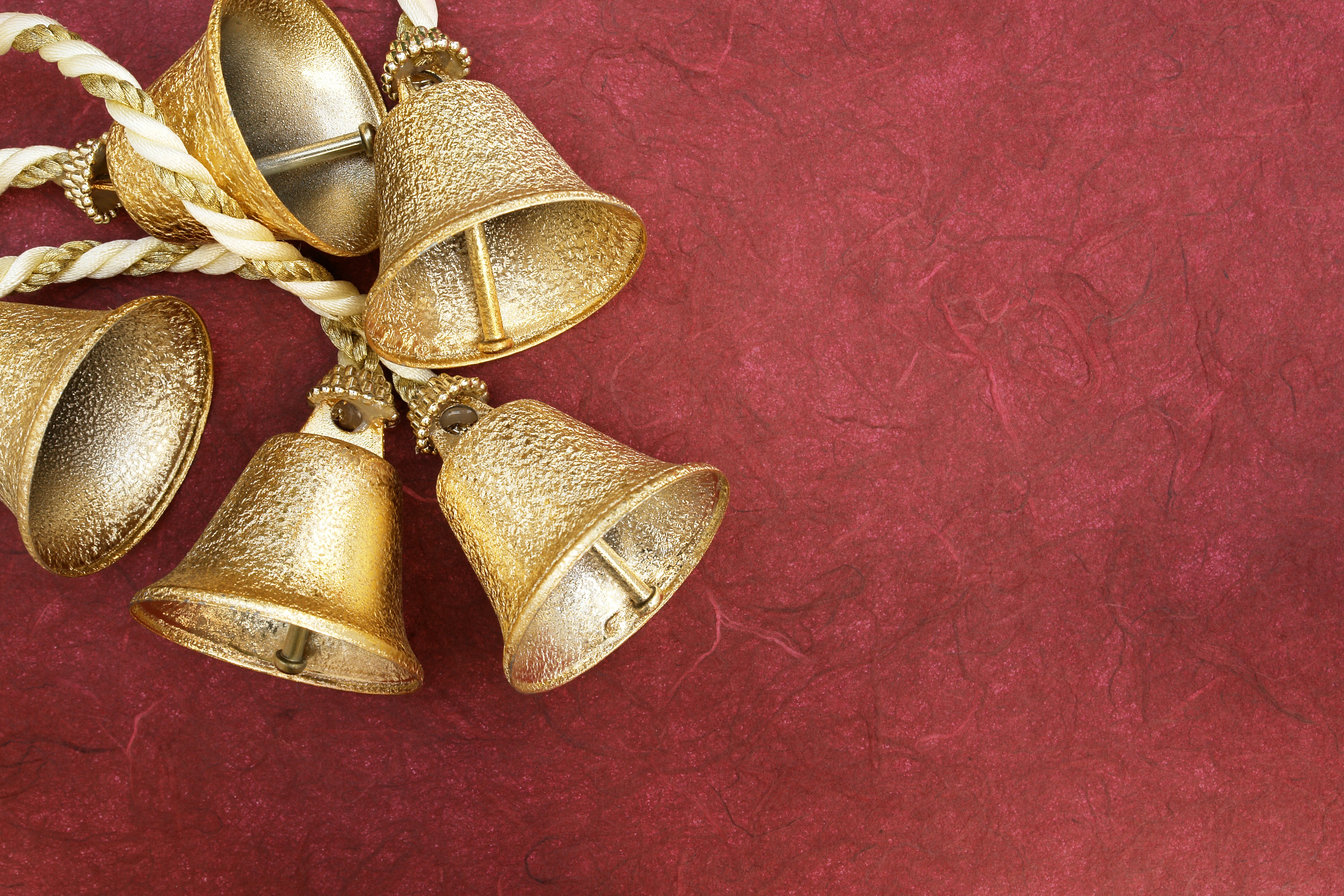 Gold Christmas bells on a red background