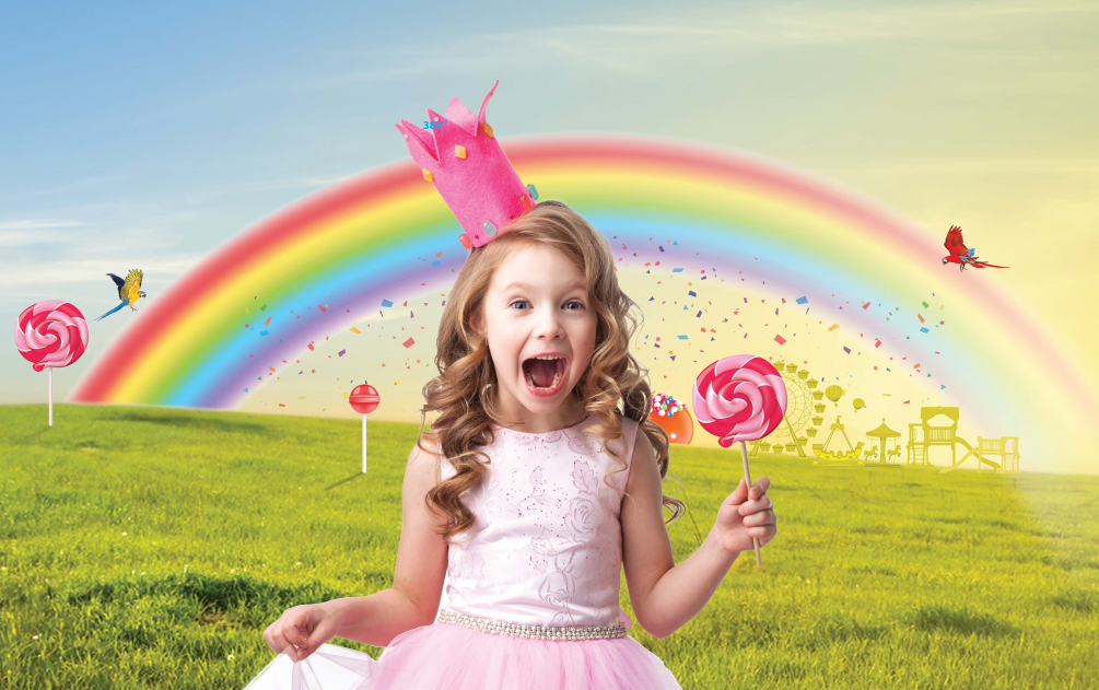 Little girl wearing a pink dress standing in front of a rainbow graphic