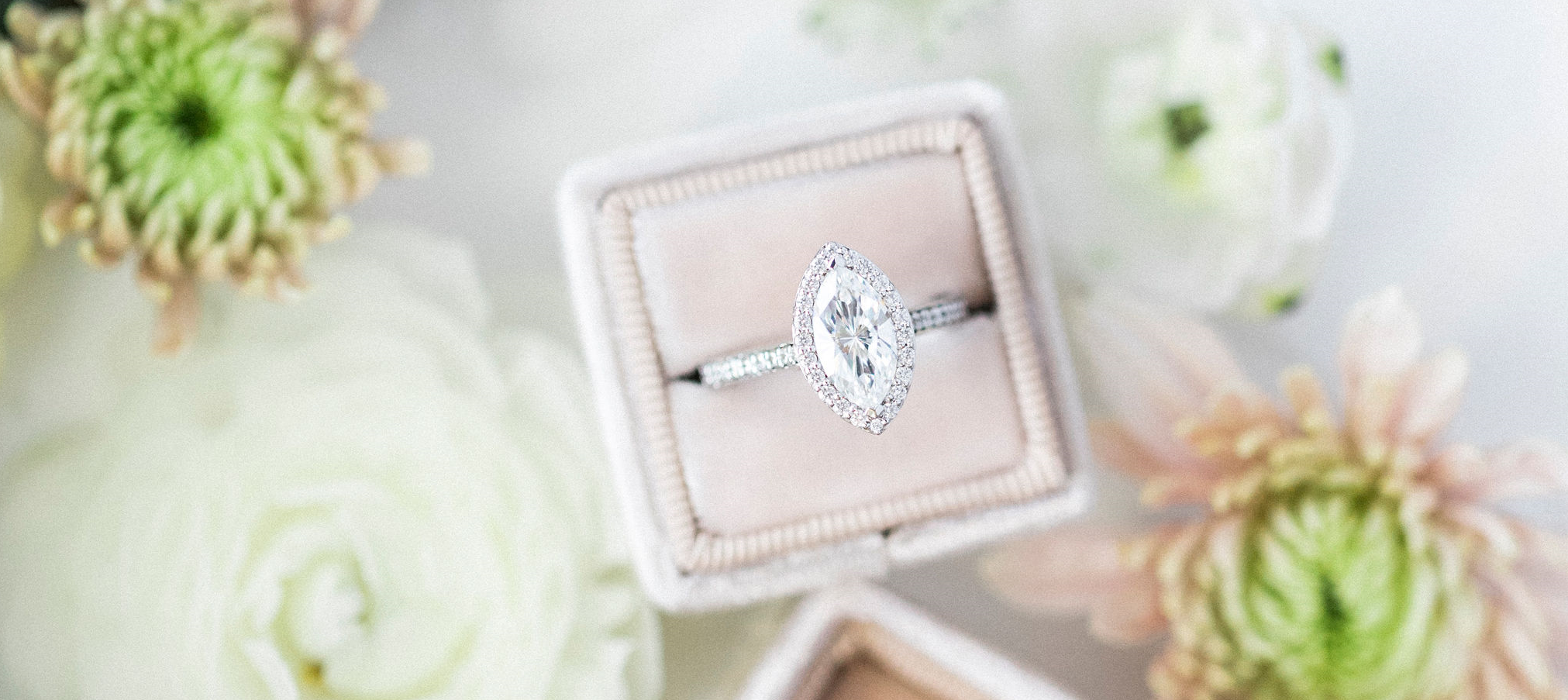 diamond ring with surrounding flowers.