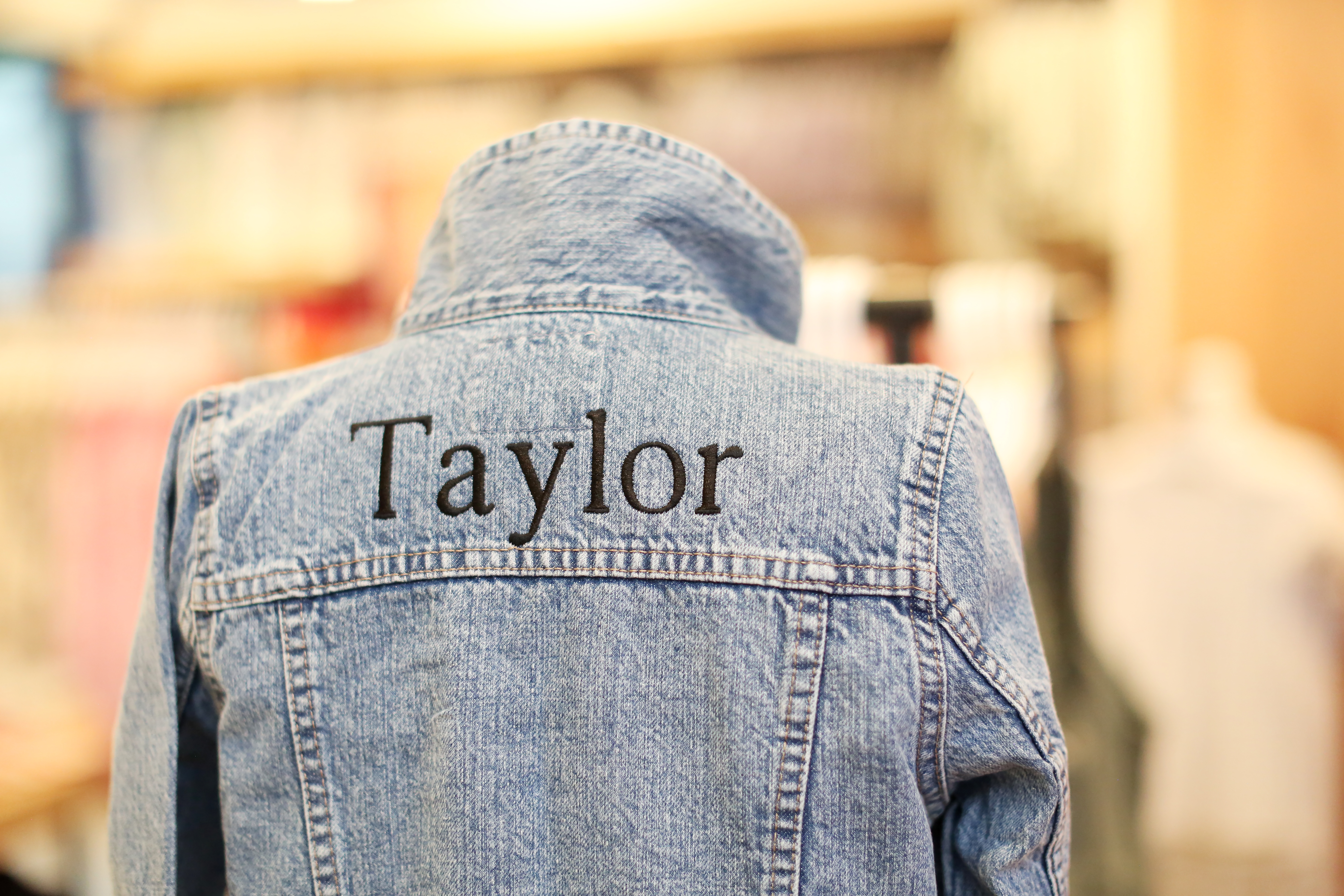 Kid's Jean Jacket that is monogramed with the word "Taylor".