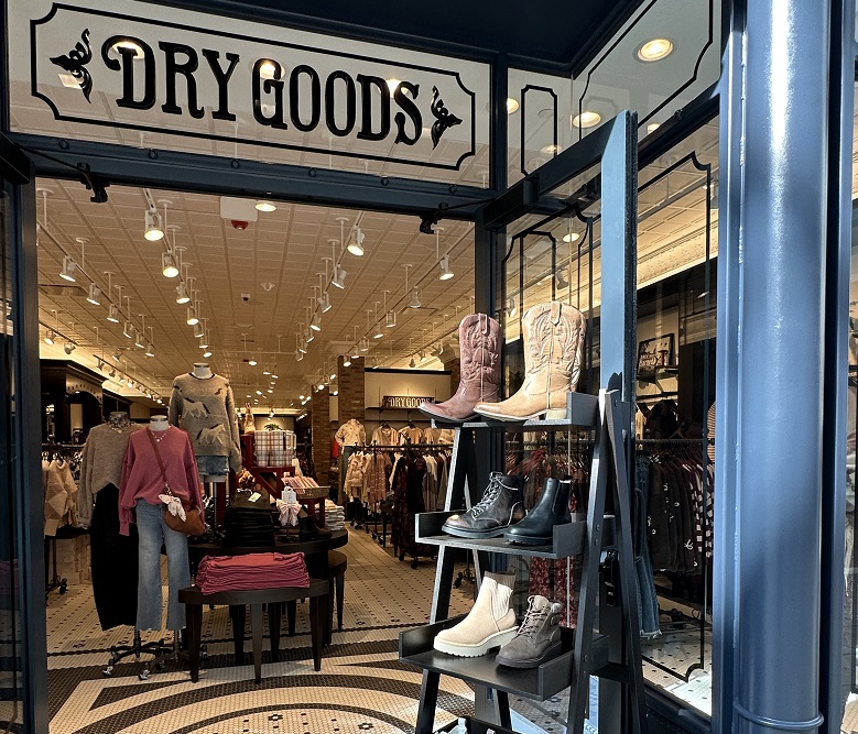 front of the Dry Goods store.  with footwear, and clothing displayed