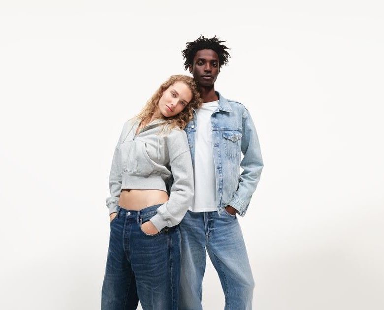 woman wearing a cropped hoodie and jeans, and man with jean, white t-shirt and denim jacket