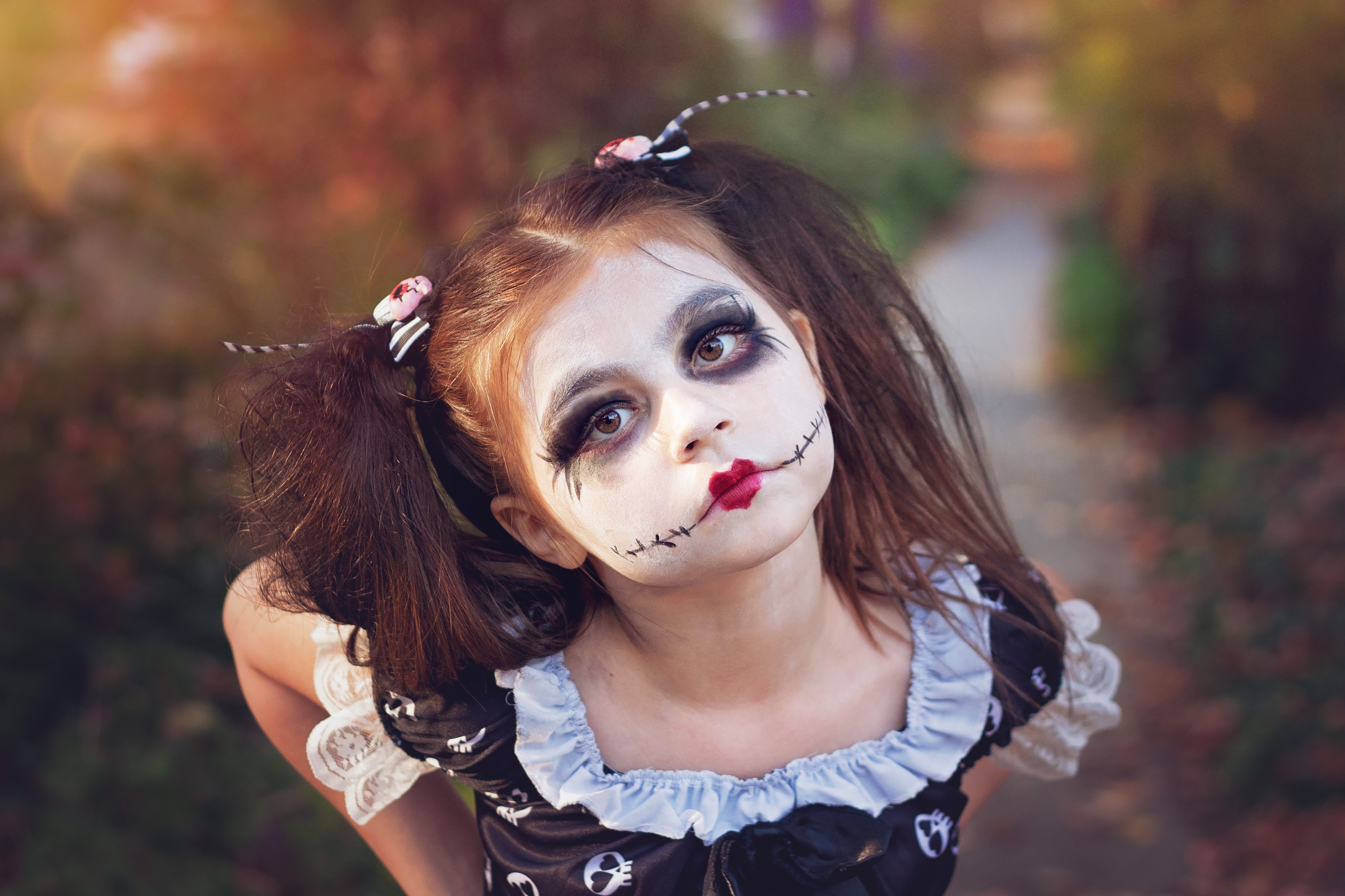 Girl with Halloween makeup and costume on