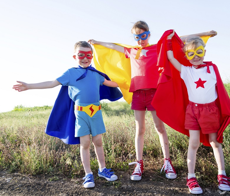 three children dressed as superheros