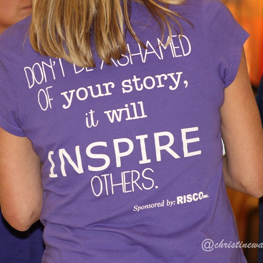 Back of purple t-shirt with wording "Don't be ashamed of your story, it will inspire others."