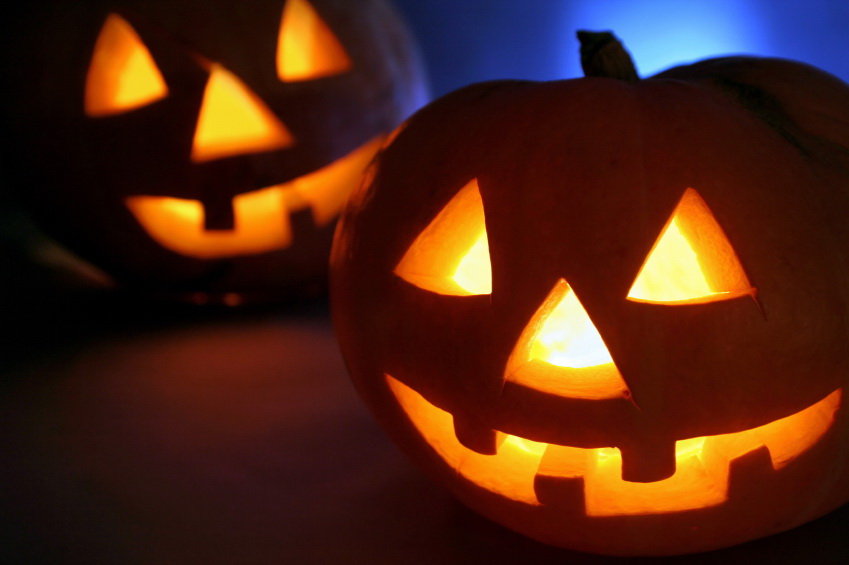 two illuminated carved pumpkins 