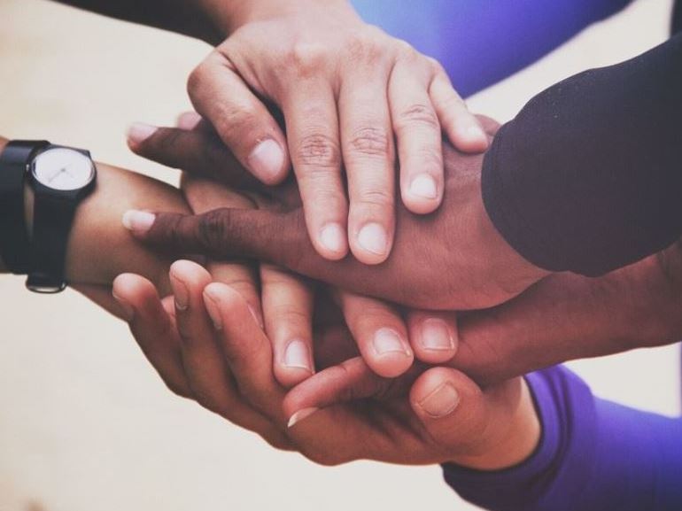 Hands stacked on top of each other