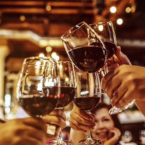 People clinking wine glasses
