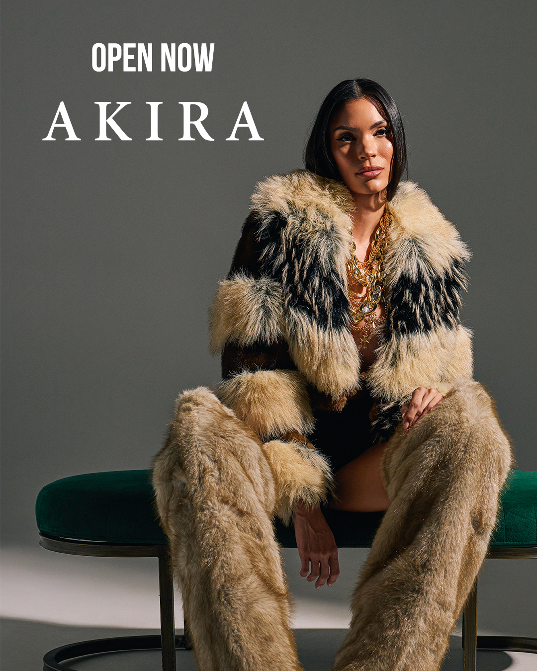 image of fashion model with black and camel colored striped fur jacket, gold jewelry, and camel colored striped fur boots