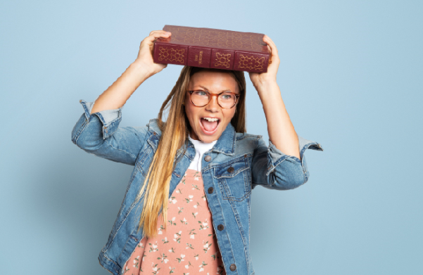 Girl with jean jacket holding with books 