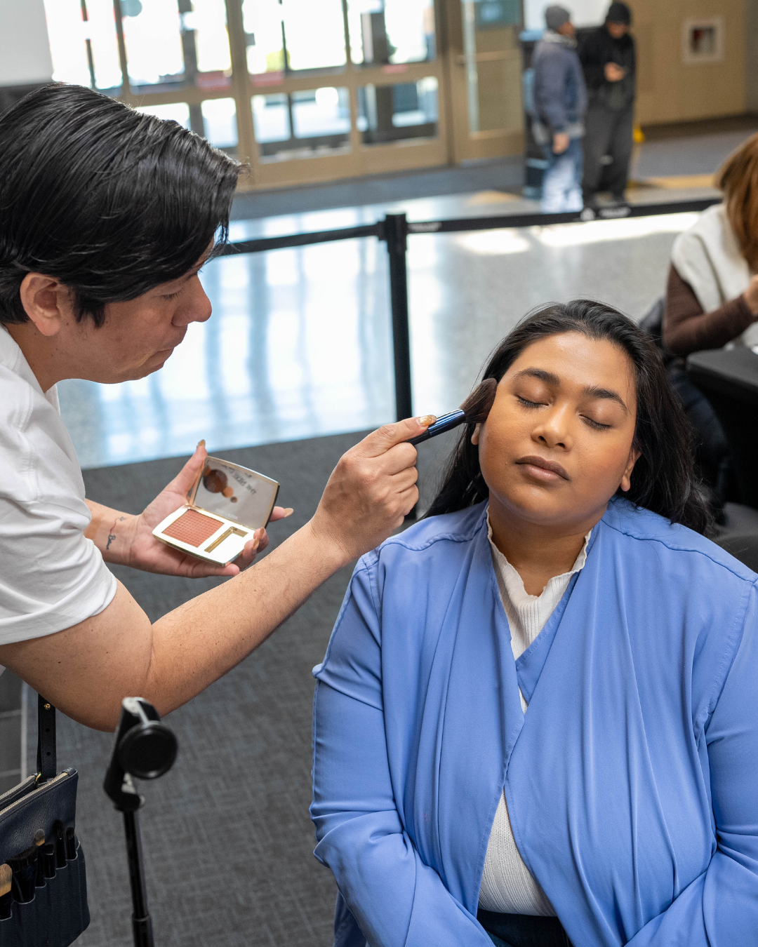 woman getting her make up done