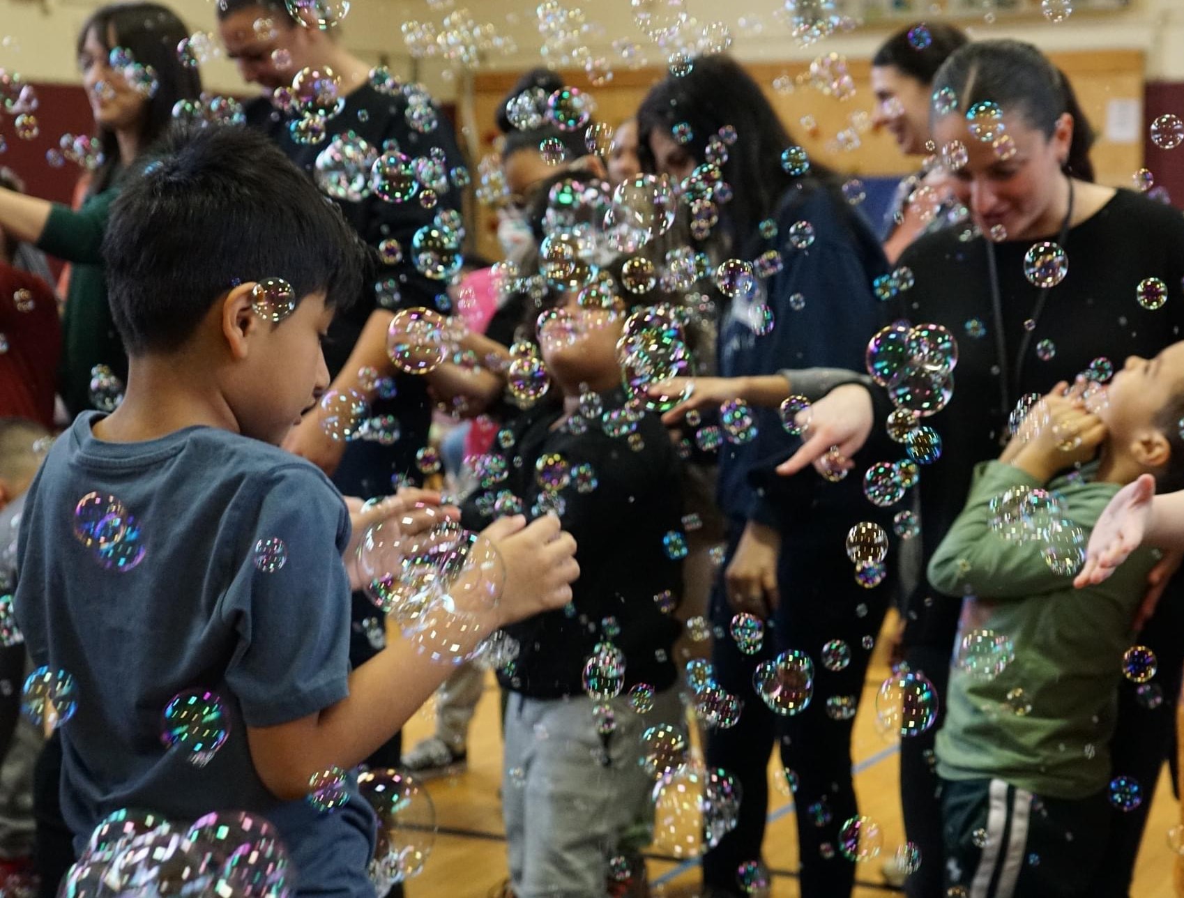 photo of people playing with bubbles