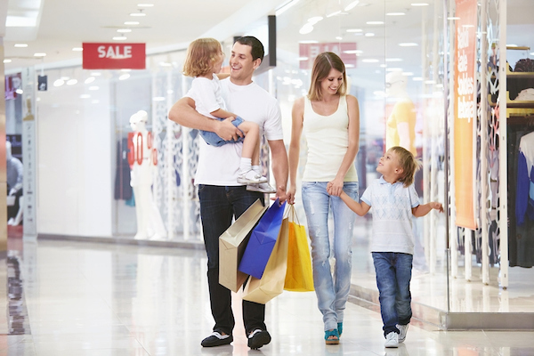 family of four walking thru the mall and smiling