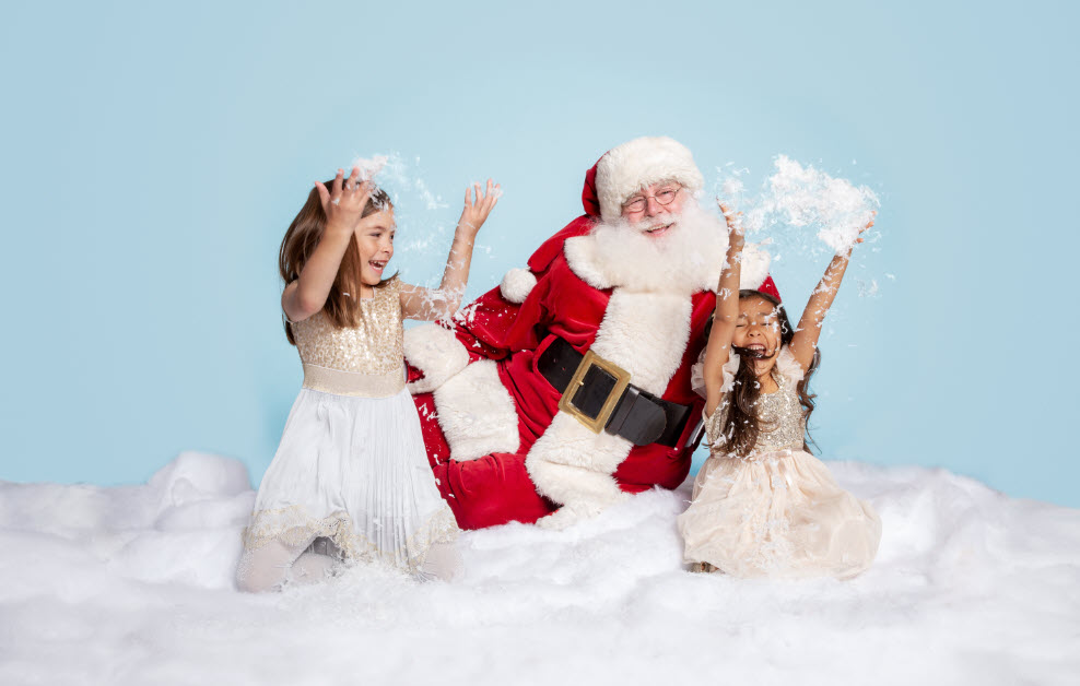 Santa and two young girls playing in snow