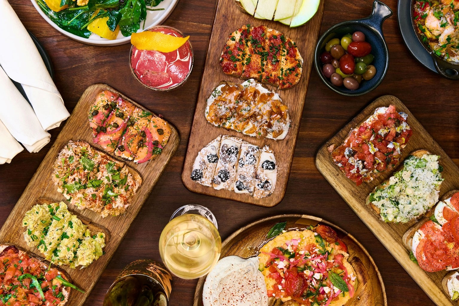 Assorted bruschetta with vibrant toppings, served with cocktails and wine at Postino WineCafé.